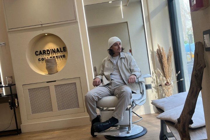 A client in the chair beside the circular Cardinale sign